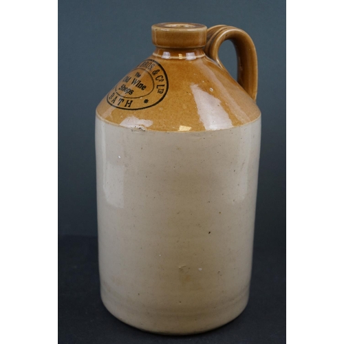 579 - A collection of four stoneware bottles to include two Bath advertising examples.