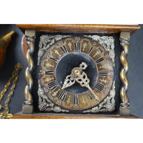 584 - A contemporary wooden wall clock with brass embellishments and a twin train movement.