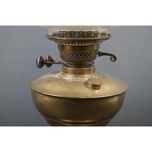 587 - A brass oil lamp with white glass shade.