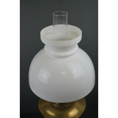 587 - A brass oil lamp with white glass shade.