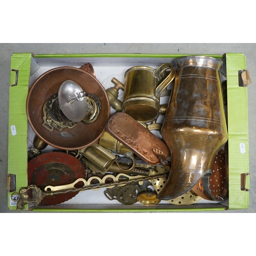 589 - A mixed collection of brass and copper ware to include a calendar, horse brasses and beer taps.