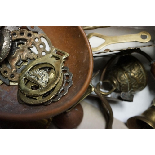 589 - A mixed collection of brass and copper ware to include a calendar, horse brasses and beer taps.