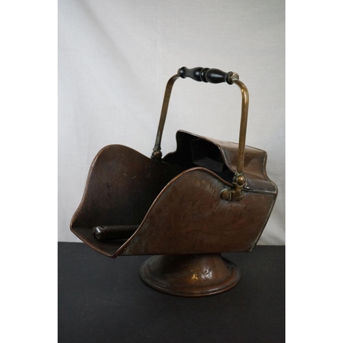 590 - Two antique copper coal scuttles together with a shovel.