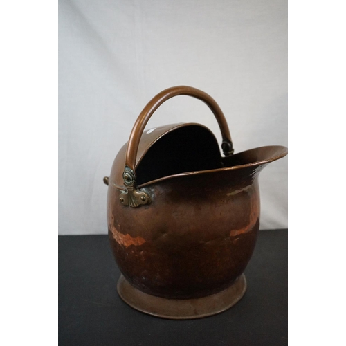 590 - Two antique copper coal scuttles together with a shovel.