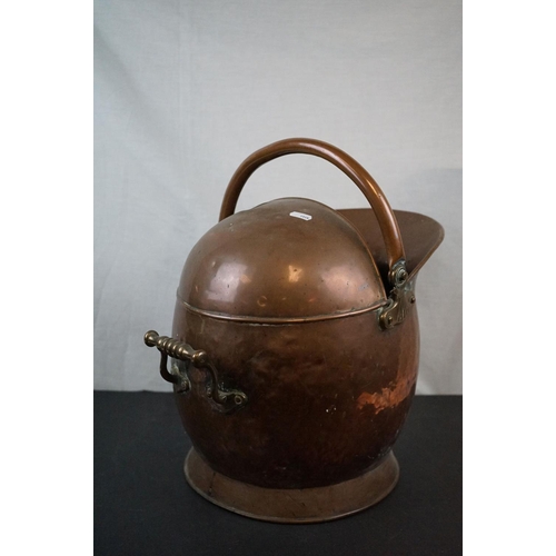 590 - Two antique copper coal scuttles together with a shovel.