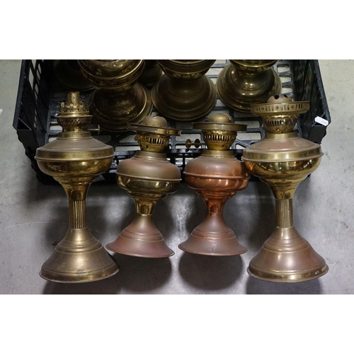 591 - A collection of nine copper and brass oil and gas lamps.