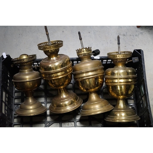 591 - A collection of nine copper and brass oil and gas lamps.