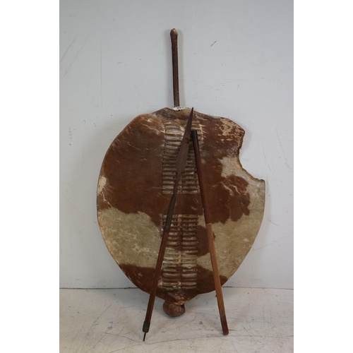 593 - An antique Zulu shield with integral knobkerry together with spear.