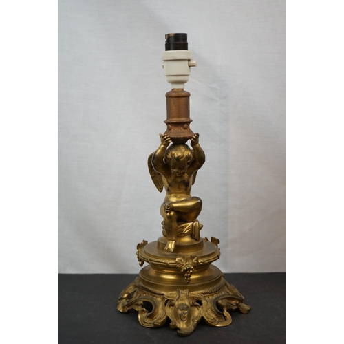 594 - Three brass table lamps to include a brass Corinthian Column and a cherub example together with a br... 