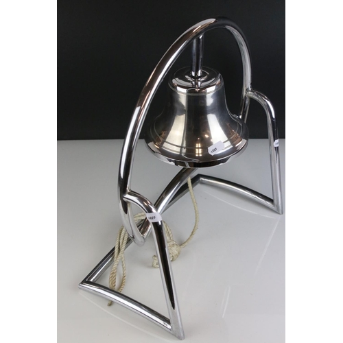 147 - Art Deco White Metal Bell fixed onto a Stand, 38cms high