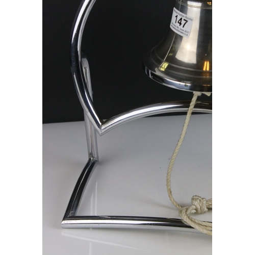 147 - Art Deco White Metal Bell fixed onto a Stand, 38cms high