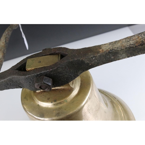 151 - Large Antique Bronze / Bell Metal Bell with Clanger and held on a cast iron bracket, bell 30cms high