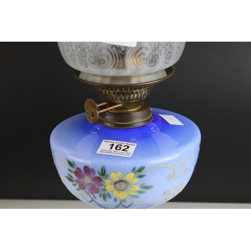 162 - Victorian Oil Lamp with Etched Fluted Blue Tinted Shade, Blue Ceramic Floral Painted Font and Brass ... 