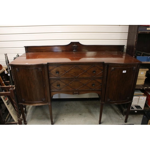 703 - Regency style Mahogany Sideboard with two central drawers flanked by two bow fronted cupboards (one ... 