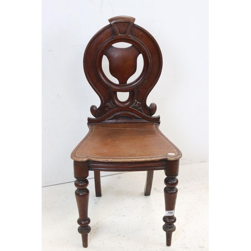 706 - 19th century Mahogany Hall Chair with carved circular back and solid seat, 92cms high