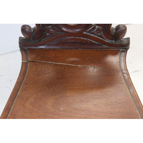 706 - 19th century Mahogany Hall Chair with carved circular back and solid seat, 92cms high