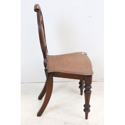 706 - 19th century Mahogany Hall Chair with carved circular back and solid seat, 92cms high