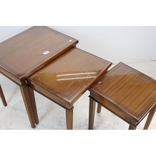 769 - Mahogany effect Nest of Three Tables with glass covers, largest 53cms wide x 54cms high