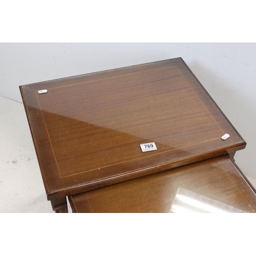 769 - Mahogany effect Nest of Three Tables with glass covers, largest 53cms wide x 54cms high