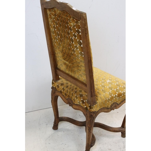 771 - A mustard upholstered antique walnut hall chair with carved shell decocoration.