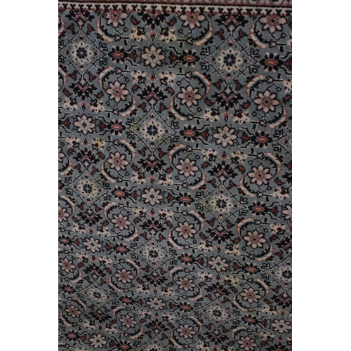 823 - Green and Cream Ground Rug with floral pattern, approx. 171cms x 121cms