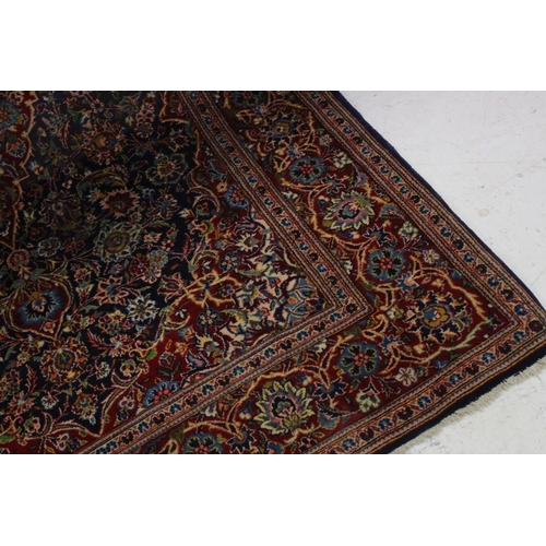 831 - Red and Blue Ground Rug with stylised floral pattern, approx. 202cms x 135cms