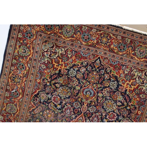 831 - Red and Blue Ground Rug with stylised floral pattern, approx. 202cms x 135cms