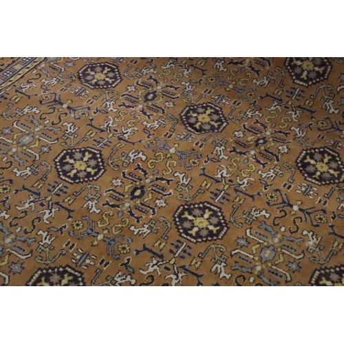 832 - Large Orange, Blue and Purple Ground Rug with stylised pattern to central panel surrounded by floral... 