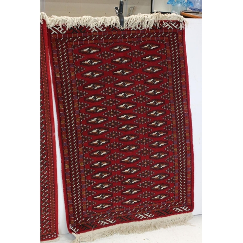 833 - Pair of Red Ground Bokhara style Wool Rugs, 121cms x 81cms