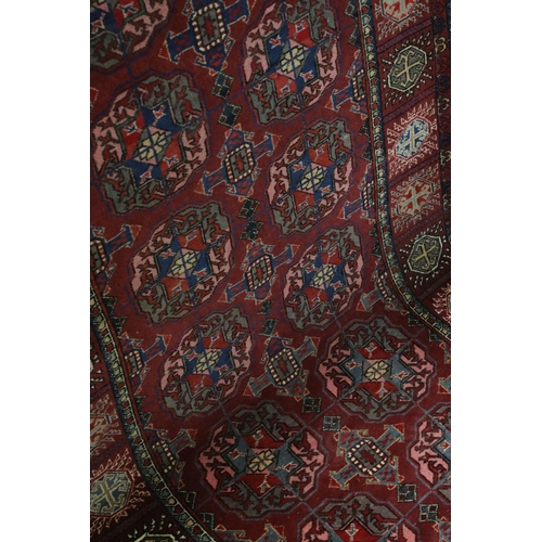 834 - Dark Red Ground Wool Rug with Geometric Pattern to centre surrounded by a border of square panels, 1... 