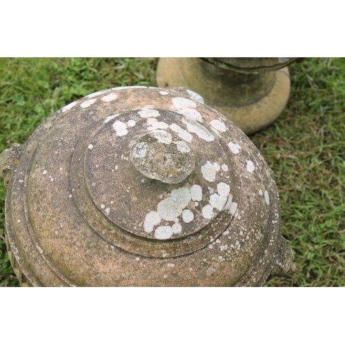 691 - A group of five stone urn shaped lion wall finials. measuring approx 46cm in height. (understood to ... 