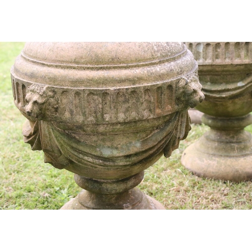 691 - A group of five stone urn shaped lion wall finials. measuring approx 46cm in height. (understood to ... 