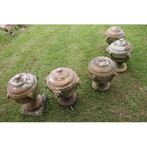 691 - A group of five stone urn shaped lion wall finials. measuring approx 46cm in height. (understood to ... 