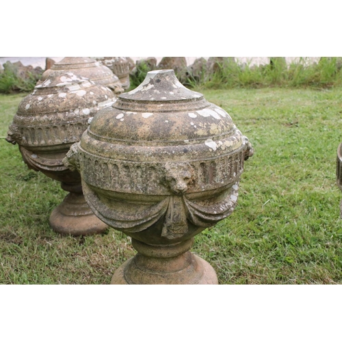 691 - A group of five stone urn shaped lion wall finials. measuring approx 46cm in height. (understood to ... 