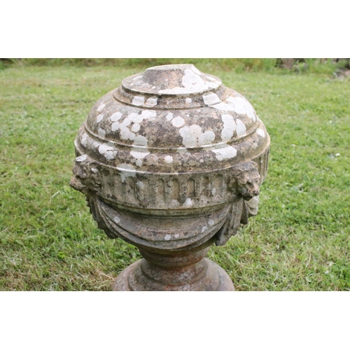 691 - A group of five stone urn shaped lion wall finials. measuring approx 46cm in height. (understood to ... 