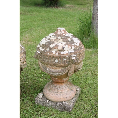 691 - A group of five stone urn shaped lion wall finials. measuring approx 46cm in height. (understood to ... 