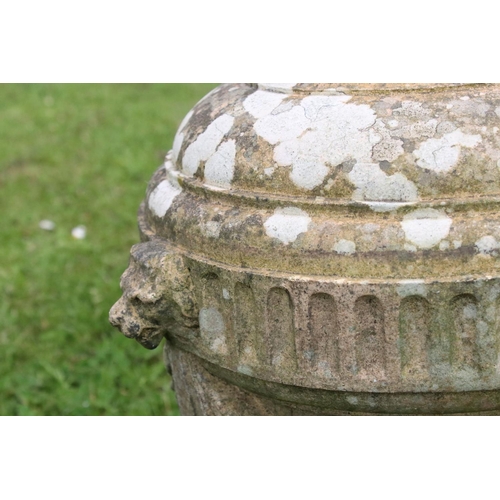 691 - A group of five stone urn shaped lion wall finials. measuring approx 46cm in height. (understood to ... 