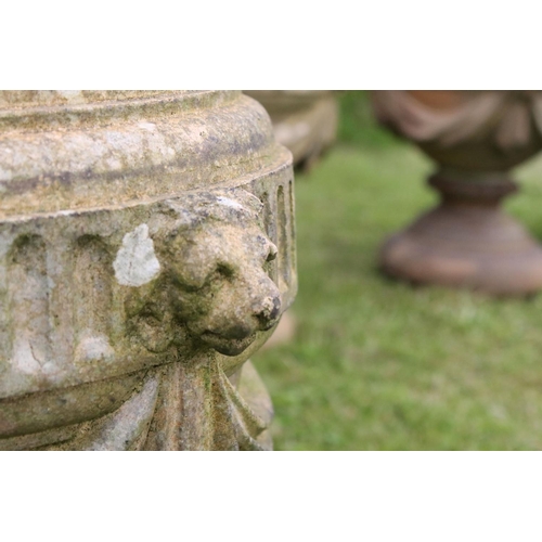 691 - A group of five stone urn shaped lion wall finials. measuring approx 46cm in height. (understood to ... 