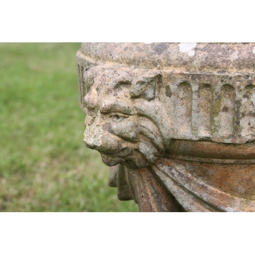 691 - A group of five stone urn shaped lion wall finials. measuring approx 46cm in height. (understood to ... 