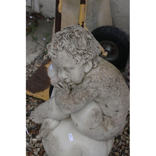 695 - A reconstituted stone wall finial with seated child to top, stands approx 64cm tall