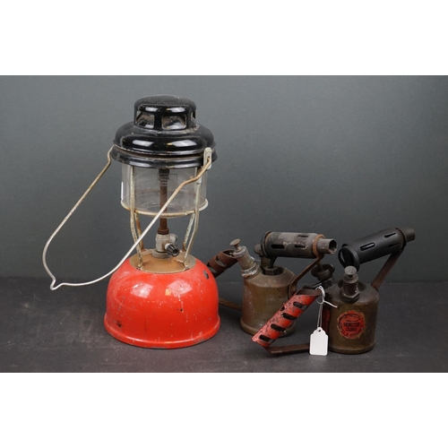 613 - A vintage storm lantern together with two vintage blow torches.