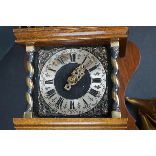 629 - A contemporary wall clock with ornate brass decoration and two train movement.