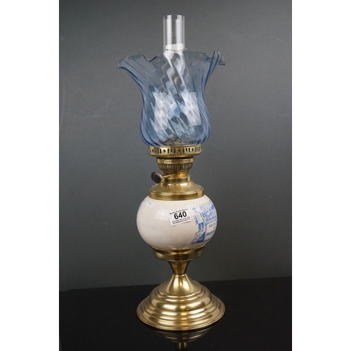 640 - An Edwardian brass oil lamp with advertising, Solon Caddy's Fine Groceries, with blue scrolling shad... 