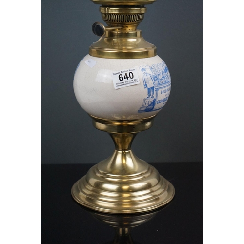 640 - An Edwardian brass oil lamp with advertising, Solon Caddy's Fine Groceries, with blue scrolling shad... 