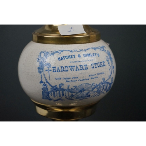 640 - An Edwardian brass oil lamp with advertising, Solon Caddy's Fine Groceries, with blue scrolling shad... 