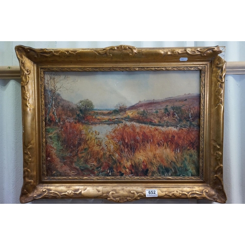 652 - A gilt framed watercolour landscape with indistinct signature, titled 'S Devon,' 36 x 51 cm.