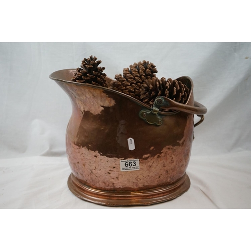 663 - An antique helmet copper coal bucket together with a table lamp.