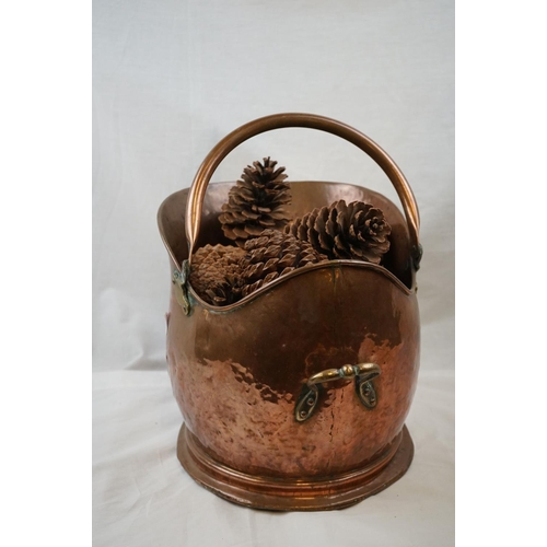 663 - An antique helmet copper coal bucket together with a table lamp.