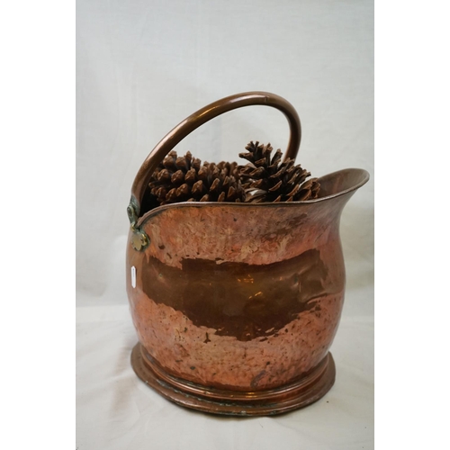 663 - An antique helmet copper coal bucket together with a table lamp.