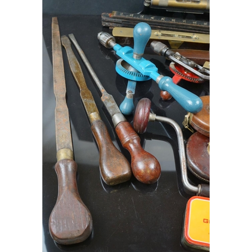 667 - A collection of vintage tools to include Drills, Chisels, Tapes and levels.